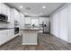 Open kitchen with island, white cabinets and gray counters at 9936 Coyote Echo Ct, Las Vegas, NV 89166