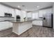 Bright kitchen, an island, white cabinets and stainless steel appliances at 9936 Coyote Echo Ct, Las Vegas, NV 89166