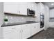 Modern kitchen with white cabinets and stainless steel appliances at 9936 Coyote Echo Ct, Las Vegas, NV 89166