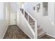 Modern staircase with metal railing and wood-look tile flooring at 9936 Coyote Echo Ct, Las Vegas, NV 89166