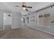 A spacious carpeted bedroom featuring natural light and neutral gray walls with white trim at 1676 Tristan Flower Ave, Las Vegas, NV 89183