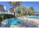 Inviting community hot tub near the pool with palm trees at 1676 Tristan Flower Ave, Las Vegas, NV 89183