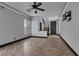 Bright living room featuring tile flooring, a ceiling fan, and multiple windows at 1676 Tristan Flower Ave, Las Vegas, NV 89183