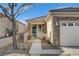 Home's entrance with stone accents, walkway, and small front yard at 2601 Darda St, Henderson, NV 89044