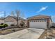 House exterior showcasing stone and stucco siding, two-car garage, and a manicured yard at 2601 Darda St, Henderson, NV 89044