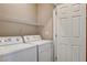 Laundry room with washer, dryer, and shelving at 2601 Darda St, Henderson, NV 89044