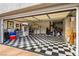 Garage with checkerboard flooring, storage, and shelving at 2709 Orchid Valley Dr, Las Vegas, NV 89134