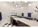 Bathroom featuring dual vanities with marble countertops and checkered tile flooring at 1282 Calcione Dr, Henderson, NV 89011