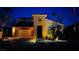 Charming home with stone accents, illuminated by landscape lighting at twilight at 1282 Calcione Dr, Henderson, NV 89011