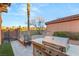 This outdoor kitchen features a grill with a countertop bar and views of the golf course at 1282 Calcione Dr, Henderson, NV 89011