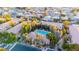 Aerial view of condo community with pool, lush landscaping, and surrounding neighborhood at 2151 Hussium Hills St # 207, Las Vegas, NV 89108