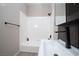 Modern bathroom features a shower-tub combo, sleek vanity, and black hardware at 2151 Hussium Hills St # 207, Las Vegas, NV 89108