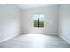 Simple bedroom with wood-look floors and one window at 2151 Hussium Hills St # 207, Las Vegas, NV 89108