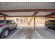 Exterior view of covered parking spaces with a stucco apartment building in the background at 2151 Hussium Hills St # 207, Las Vegas, NV 89108