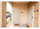 A condo entrance featuring tan stucco, unique doors, and desert landscaping at 2151 Hussium Hills St # 207, Las Vegas, NV 89108