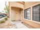 Close up of condo front door with tan stucco and covered parking view at 2151 Hussium Hills St # 207, Las Vegas, NV 89108