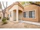 Inviting two-story condo with an arched entryway and desert landscaping at 2151 Hussium Hills St # 207, Las Vegas, NV 89108