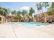 Inviting community pool with refreshing clear water surrounded by mature trees and wrought iron fencing at 2151 Hussium Hills St # 207, Las Vegas, NV 89108