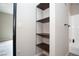 Open wood shelving provides ample storage in a convenient location near the bath at 2151 Hussium Hills St # 207, Las Vegas, NV 89108