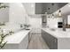 Sleek kitchen with white cabinets, herringbone backsplash, and an island at 31 Vista Outlook St, Henderson, NV 89011