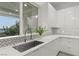 Modern kitchen features stainless steel sink and herringbone tile backsplash at 31 Vista Outlook St, Henderson, NV 89011