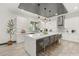 Modern kitchen with white cabinets, marble island, and herringbone backsplash at 31 Vista Outlook St, Henderson, NV 89011