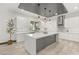 Contemporary kitchen featuring a large island and white cabinets at 31 Vista Outlook St, Henderson, NV 89011