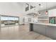 Modern kitchen with island, stainless steel appliances, and white cabinetry at 31 Vista Outlook St, Henderson, NV 89011