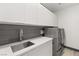 Spacious laundry room with sink, cabinets, and modern washer/dryer at 31 Vista Outlook St, Henderson, NV 89011