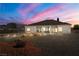 Landscaped backyard with lighting at dusk at 3780 Shawnee Ave, Pahrump, NV 89048