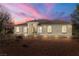 House exterior at dusk, showcasing its curb appeal at 3780 Shawnee Ave, Pahrump, NV 89048