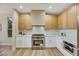 Modern kitchen with white cabinets, stainless steel appliances, and light wood accents at 4660 Fiore Bella Blvd, Las Vegas, NV 89135