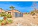 Backyard with shed, desert landscaping, and partial pool view at 5527 Breecher Ave, Las Vegas, NV 89131