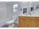 Clean bathroom with wood vanity and neutral color scheme at 5527 Breecher Ave, Las Vegas, NV 89131