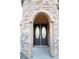 Elegant arched entryway with double doors and stone facade at 5527 Breecher Ave, Las Vegas, NV 89131