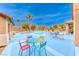 Poolside patio with colorful tables and chairs at 5527 Breecher Ave, Las Vegas, NV 89131