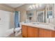 Clean bathroom with a tub shower, toilet and wood vanity at 9017 Exultation Ct, Las Vegas, NV 89149