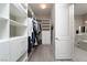 Spacious walk-in closet with custom shelving and drawers providing ample storage space at 11 Via Tavolara, Henderson, NV 89011