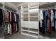 Walk-in closet with custom shelving and racks for organized storage of clothing and accessories at 11 Via Tavolara, Henderson, NV 89011