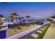 Landscaped backyard with a pool and LED lighting at dusk at 4160 W Ford Ave, Las Vegas, NV 89139