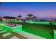 Landscaped backyard with a pool and LED lighting at dusk at 4160 W Ford Ave, Las Vegas, NV 89139