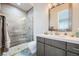 Modern bathroom with a walk-in shower, floating vanity, and grey tile at 4160 W Ford Ave, Las Vegas, NV 89139