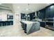 Open-concept kitchen with an oversized island, stainless steel appliances, and stylish pendant lighting at 4160 W Ford Ave, Las Vegas, NV 89139
