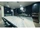 Sleek kitchen boasting a large island with stunning countertops and dark cabinetry at 4160 W Ford Ave, Las Vegas, NV 89139
