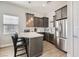 Modern kitchenette with stainless steel appliances and a breakfast bar at 4160 W Ford Ave, Las Vegas, NV 89139