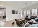 Comfortable living room with leather sectional sofa, a large TV, and wood-look floors at 4160 W Ford Ave, Las Vegas, NV 89139