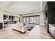 Open concept living room with large windows, fireplace, and access to backyard at 4160 W Ford Ave, Las Vegas, NV 89139