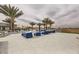 Spacious pool patio with blue lounge chairs and palm trees at 4160 W Ford Ave, Las Vegas, NV 89139