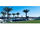 Expansive pool area with multiple seating areas and palm trees at 4160 W Ford Ave, Las Vegas, NV 89139