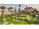 Expansive putting green surrounded by palm trees and rocks at 4160 W Ford Ave, Las Vegas, NV 89139